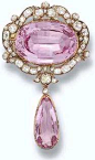 Antique Pink Topaz and Diamond Pendant Brooch. The central oval pink topaz within a scroll border of cushion-shaped diamonds suspending a detachable topaz and diamond drop, mounted in silver and gold.  Circa 1860.  This brooch was purchased by H.R.H. The 