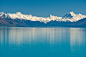 snowy mountains and rural lake