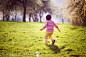 Little boy, running in the park, chasing soap bubbles by Tatyana Tomsickova