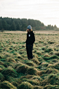 man standing on green grass field