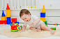 baby playing with educational toys lying by Yuliya  Shangarey Shangarey on 500px