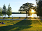 people walking on sidewalk near body of water during daytime