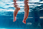 Close up of legs of baby submerged underwater by Gable Denims on 500px
