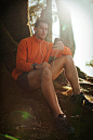 Young man listening to music in forest