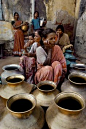 Women waiting to fill their brass pots with water 1983. India by Steve McCurry