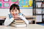 Royalty-free Image: Young student holding books in classroom