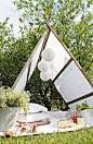 Build your own garden tent.  Step by step is here: http://mariefriis.blogspot.no/2012/06/10-pinner-28-skruer-en-duk-og-fire.html: