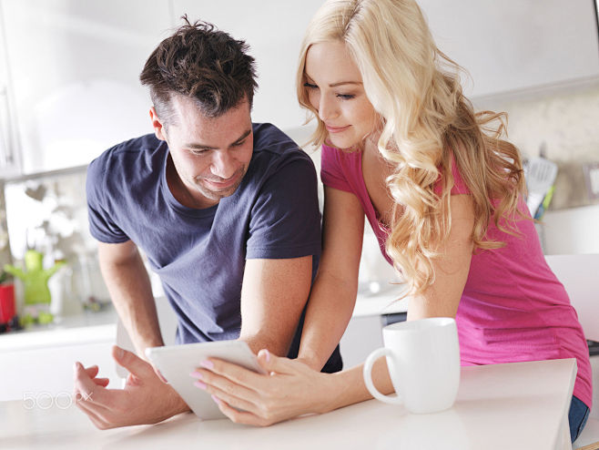 couple using tablet ...