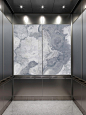LightPlane Panels with ViviStone Pearl Onyx glass, Pearlex finish shown not illuminated in a LEVELe-106 Elevator Interior with large accent panels in ViviChrome Chromis glass with Slate Blue interlayer and Pearlex finish; small accent panels in Stainless