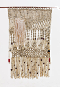 Macrame Wall Hanging with varnished wood beads : This modern macrame wall hanging comes hung on a piece of bamboo and is adorned with varnished wood beads.  It is made with over 300 feet of