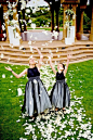 Black Flower Girl Dresses--Flower girls donned unique dresses featuring black bodices, sparkling sashes, and white skirts with sheer black overlays. 