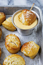 Dipping a pretzel bite in cheddar cheese sauce.