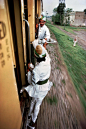 Breakfast tea being passed between train cars in Peshawar, Pakistan, 1983 via reddit