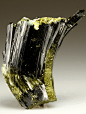 themineralogist:

Epidote specimen from Austria. The Epidote displays a curved formation due to tectonic movement during the growth stage of the crystal.
