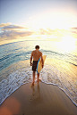 Caucasian teenage boy carrying surfboard on beach by Gable Denims on 500px