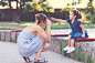 Mother taking photo of her child with old camera