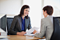 Royalty-free Image: Businesswomen with paperwork talking face to face
