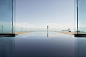 Woman walking near infinity pool overlooking scenic view by Gable Denims on 500px