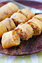 Chopped fried Asian spring rolls filled with vegetables on a plate.