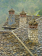 This may contain: the roof of an old building with stone chimneys and tiled roofs is shown in this artistic photo