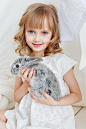 Smiling Girl Holding Gray Rabbit