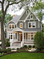 Example of a classic gray two-story wood gable roof design in Chicago