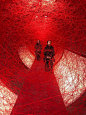 chiharu shiota weaves webs around two seated performers, 100 years after WWI