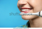 Young woman with electric toothbrush on color background, closeup. Space for text