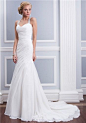 Absolutely beautiful wedding dress. Chiffon fit and flare features asymmetrical pleating and a beaded halter neckline with a criss-cross keyhole back. Gown has chapel length train and chiffon buttons cover the zipper.