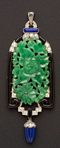 Art Deco Jadeite, Lapis, Enamel, and Diamond Pendant, the floral and foliate carved jadeite tablet within a black enamel frame, suspending a gadrooned lapis drop, old European, full, and single-cut diamond melee highlights, millegrain accents, platinum-to