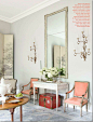 Randolph added his trademark soft pops of color with the apricot French chairs that were once placed across the room.  The walls are painted a gorgeous gray – Farrow and Ball Elephant’s Breath.  While the chairs are antiques, the console and sconces are N