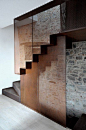 A beautiful staircase created with copper mesh, glass, and concrete.: