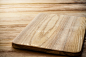 Bright cutting board on a background of the wooden table