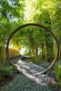 Love the moon gate - Visitors enter the garden along a shady gravel path, stepping through a moon gate: 