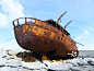 Shipwreck At Rocky Shore Against Sky