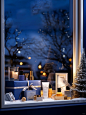 Christmas product atmosphere map, a set of skincare products, placed in a Christmas themed gift box, with ribbons, next to the windowsill, some Christmas decorations are placed. Outside the glass window, there is a dark blue snow scene at night, a Christm