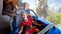 A girl and her parents hang on tight as they ride on the Matterhorn Bobsleds