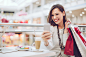 Pretty shopper taking selfies with her cell phone