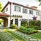 Stunning Dramatic Driveway | Soft, green grass grows between stones, reducing heat and glare. Fully functional and also beautiful, it creates a grand approach. | SouthernLiving.com