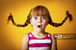 Red-Haired Girl with Upward Braids and Look of Surprise_创意图片