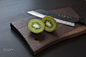 Kiwi on cutting board with knife by Peter Bajnoci on 500px