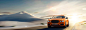 An orange Bentley Flying Spur W12 S Exterior driving on a desert road | Bentley Motors