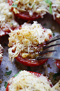 Close-up of garlic parmesan baked tomatoes with a fork.