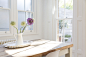 Flowers in vase on wooden table by Caia Images on 500px