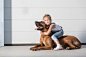 Portrait of cute girl sitting on dog outdoors by fStop_images on 500px