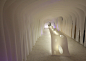 Kotaro Horiuchi creates a Paper Cave inside his architecture studio : Japanese architect Kotaro Horiuchi has created a white cave-like space in his office by hanging sheets of glass fibre paper from the ceiling.