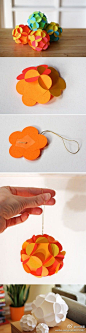 3-D paper ball ornaments with instructions and printable templates for download, by How About Orange: Made from 12 slotted flower shapes that fit together to form a sphere. No adhesive needed; the only ingredient is paper. [By Jessica Jones -please keep c