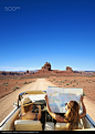 Women reading map in convertible on remote road - stock photo