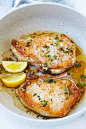 Pork Chops cooked in a skillet with garlic and butter.