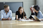 Business people reviewing paperwork in meeting by Caia Images on 500px